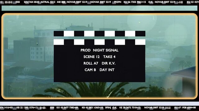 Hinged arm lifting, black clapperboard swinging down and snapping shut to mark take over hazy sky