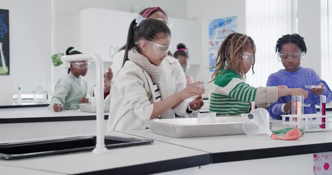 African American teacher guiding kids at lab, approaching, pouring and seeing reactions with tubes