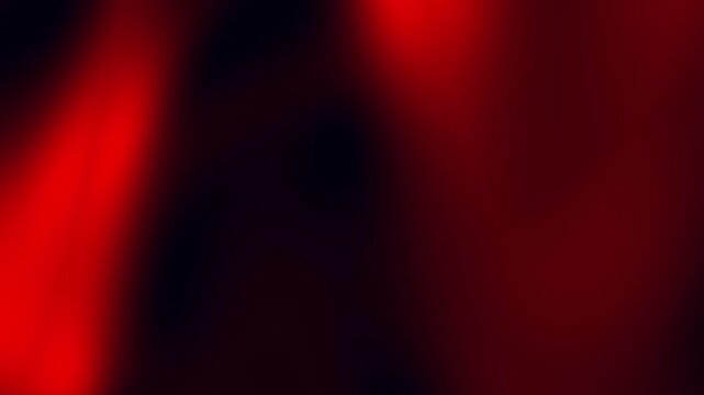 Red light casting soft shadows on a dark background, perfect for dramatic backgrounds, abstract concepts, or artistic designs.