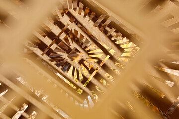 An abstract, close-up shot of a complex, laser-cut geometric design made from wooden panels © Jill Greer