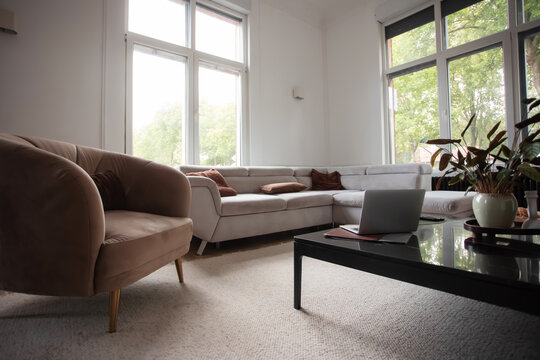 Open laptop in bright modern living room home office