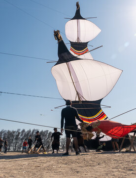 Kite flyers are carefully preparing to launch their kites, working together at Mertasari Beach, Sanur, Denpasar, Bali, on July 25, 2026.