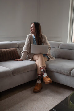 Smiling young woman taking break from remote work at home