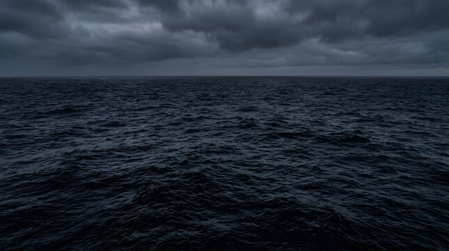 Dark stormy ocean waves under heavy cloudy sky moody seascape with brooding cloud cover evoking sense foreboding natural power seascape dominated deep