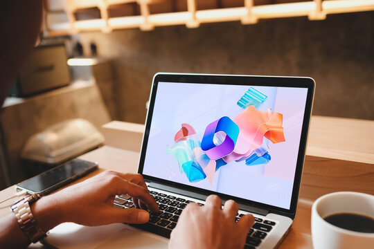 Bangkok, Thailand. July 26, 2026; A user types on a laptop displaying the Microsoft 365 logo on the screen in a modern workspace.