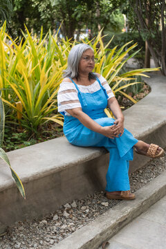 Senior woman relaxing in park contemplating new lifestyle