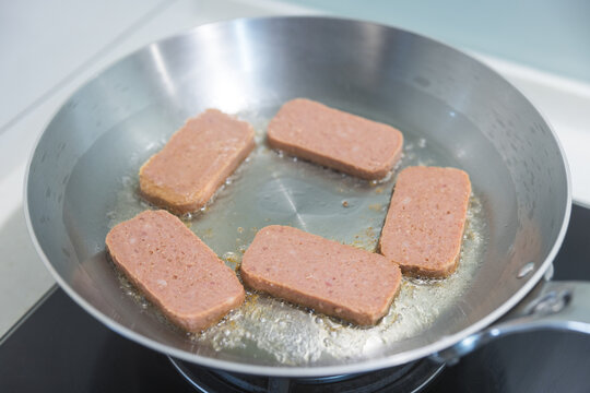 Spam luncheon meat frying in the pan