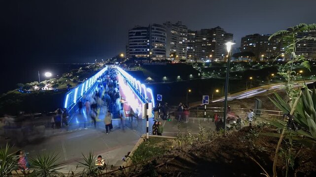 Puente de la Paz, a famous bridge in Lima, Peru: a time-lapse of people crossing the illuminated bridge at night.