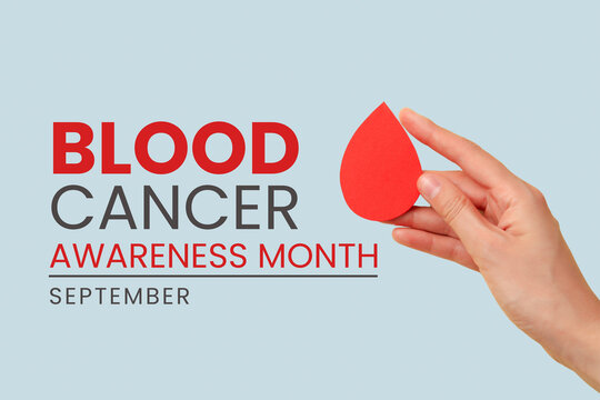 Blood cancer. Hand holds red drop shape emphasizing blood cancer awareness