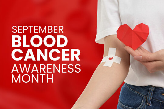 Blood cancer. Person holds paper heart while showcasing blood donation bandage on arm