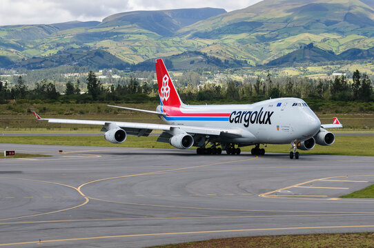 Cargolux Boeing 747-8F cargo plane taxiing at Mariscal Sucre Airport in Quito, Ecuador, with the Andes Mountains in the background.