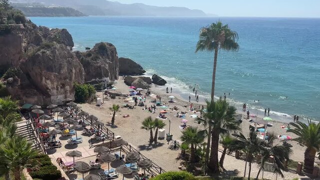 Static panoramic view of Calahonda Beach in Nerja, Spain, featuring crystal-clear Mediterranean waters, rocky cliffs and the scenic Costa del Sol coastline.