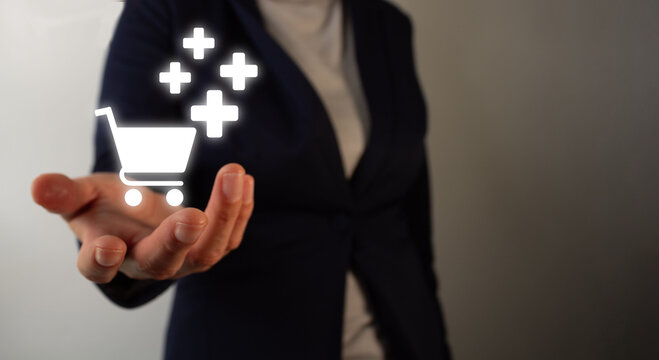 Woman in suit presents floating shopping cart symbol