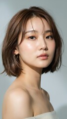 Fototapeta premium Portrait of a young asian woman with wavy brown bob hairstyle
