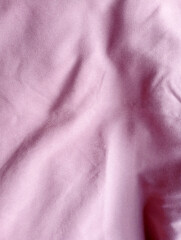 Fototapeta premium Soft pink cotton fabric texture with natural folds for design.