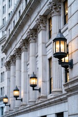 Obraz premium Ornate outdoor lanterns mounted on a grand classical building facade with Corinthian columns