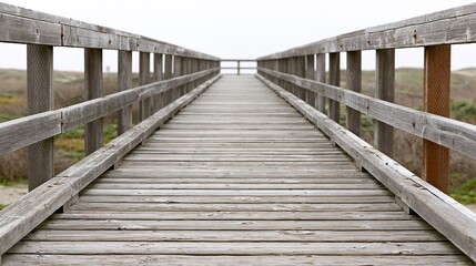 Obraz premium Wooden boardwalk leading to the ocean on a cloudy day, perfect for travel and coastal themes