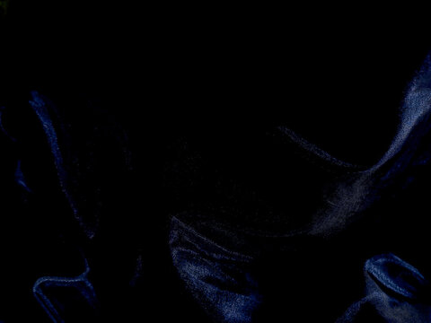 Abstract dark blue fluid waves on black background.