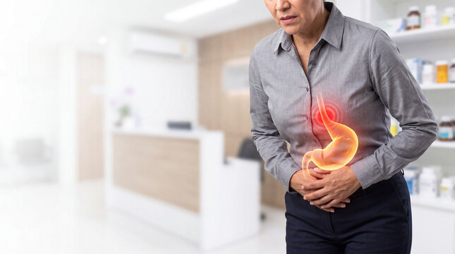 Man experiencing stomach pain with glowing internal organs. Male patient suffering from digestive discomfort in medical clinic setting.