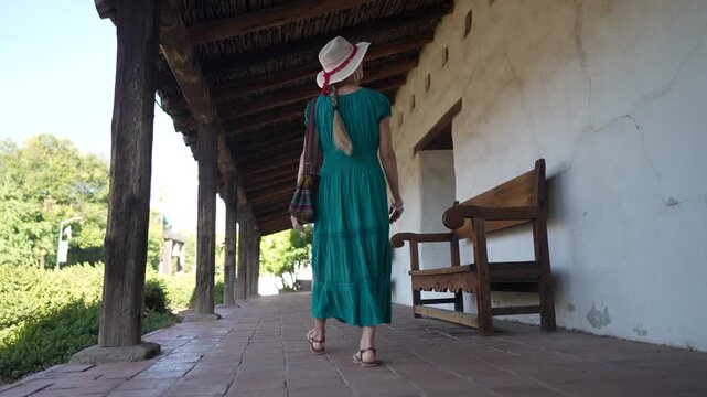 A senior woman smiles as she walks through the Mission church in Sonoma, California, exploring the historic San Francisco Solano de Sonoma.