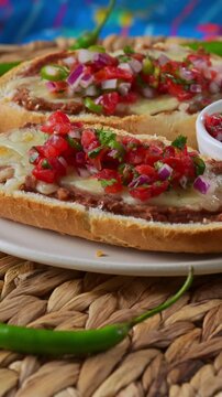 Beautifully plated molletes with vibrant colors and fresh pico de gallo salsa