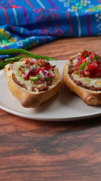 Spicy vegetarian appetizer molletes with refried beans and cilantro salsa