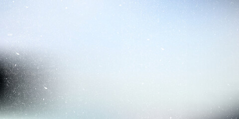 Fototapeta premium Abstract soft blue and grey gradient background with heavy film grain and dust particles, cinematic texture overlay