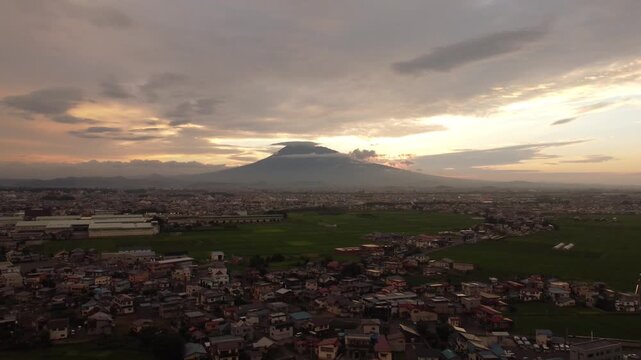 Stunning sunset over Hirosaki city residential area with majestic Mt. Iwaki in the background