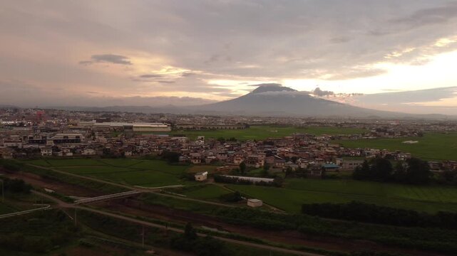 Stunning sunset over Hirosaki city residential area with majestic Mt. Iwaki in the background