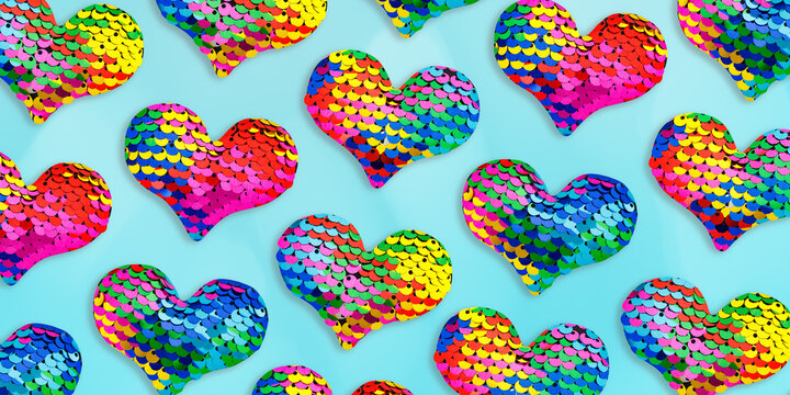 Minimal Trend pattern of multicolored hearts shape decorations covered colorful iridescent sequins. Round vibrant rainbow sequins that create fish-scale&ndash;like shimmering texture. Love holidays concept