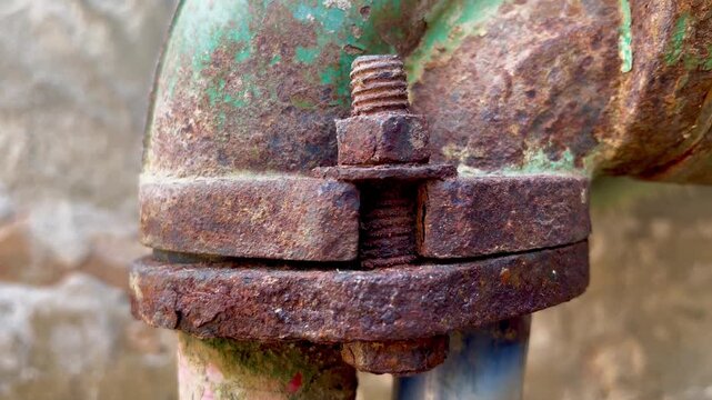 Rusted industrial pipe flange with bolt close up