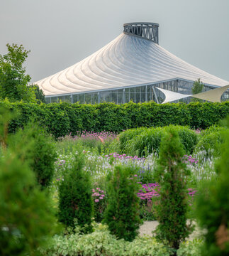 The Leaf conservatory rising above a hedged garden, Assiniboine Park