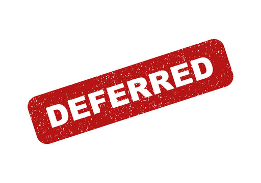 Red rubber stamp with the word deferred on a textured paper surface
