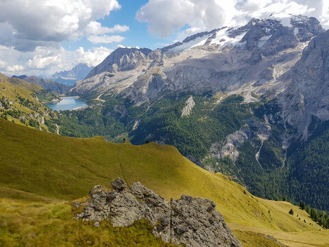 Spectacular mountain landscape overlooking Marmolada and Lago di Fedaia, inspiring outdoor adventure background