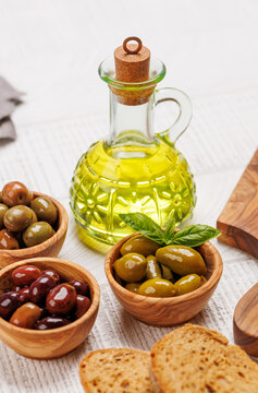 An assortment of various olives presented in a bowl, showcasing different colors and flavors