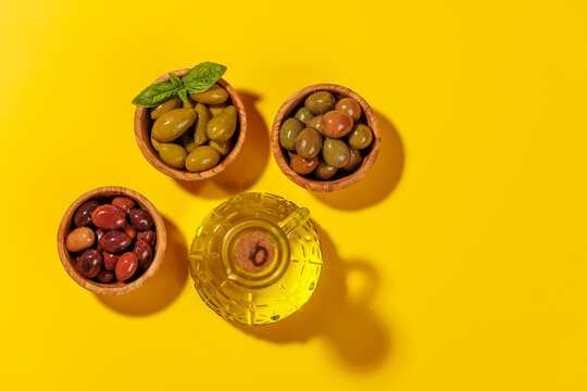 An assortment of various olives presented in a bowl, showcasing different colors and flavors