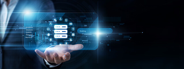 System administrator uses a handheld pad to open a virtual screen monitoring cloud Hosting services. Global network server uptimes and secure database frameworks are managed continuously. © NexPix