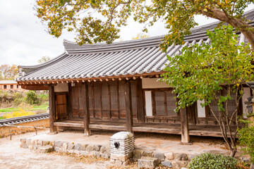 Fototapeta premium Traditional Korean Hanok Courtyard and Wooden Buildings Featuring Tiled Roofs, Eaves, and Stone Foundation