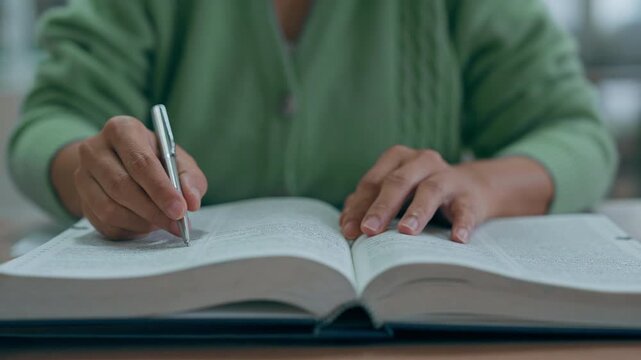 Asian woman reading book at library.