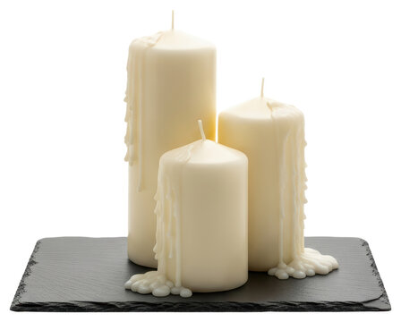 Three white pillar candles with dripping wax on slate with transparent background