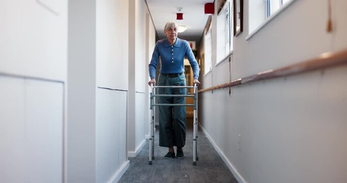 Senior, woman and hallway with walker in retirement apartment for mobility or movement in house. Elderly, female person or walking with aid or help for assistance, balance or recovery in nursing home