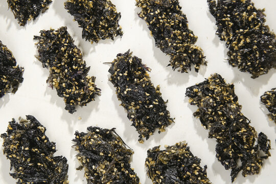 Korean Seaweed Snacks with Sesame Seeds - Traditional Asian Food Crumbles on White Background