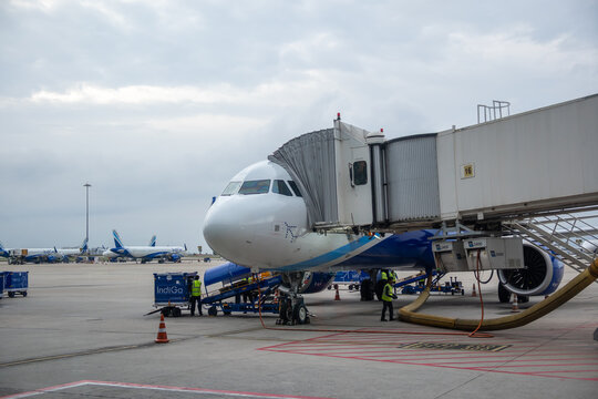 IndiGo airline passenger jet boarding at airport terminal