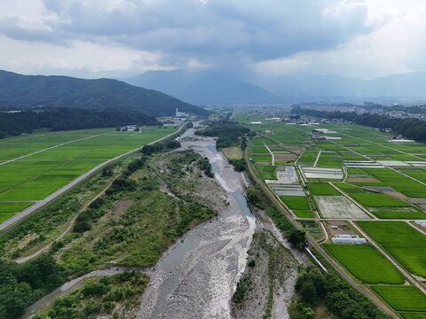 River winds through green fields, bordered by hills and farmland