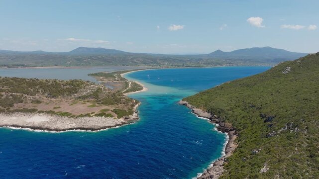 Sykia beach and Chrisi Ammos beach on a sunny day near famous Voidokilia Beach, lush Mediterranean mountain vegetation, Pilos, Messinia, Drone shot