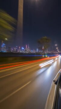 Motion timelapse of a high-speed night drive near a big city, POV from the car side window