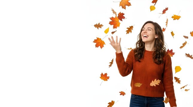 A cheerful young woman in a ribbed orange sweater laughs joyfully while surrounded by falling autumn maple and oak leaves, isolated on a white background with ample copy space.