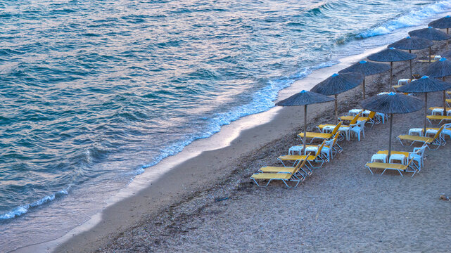 Seaside Sunbeds and Straw Parasols Along Nea Moudania Beach