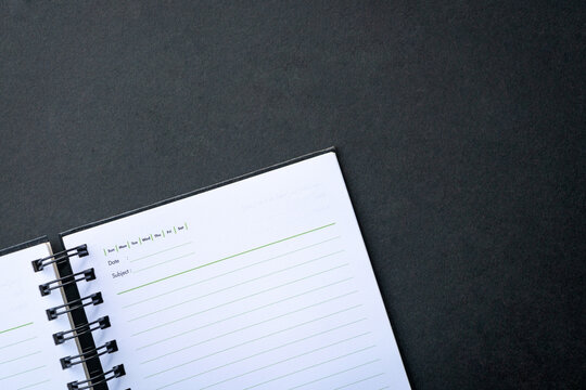 Open notepad on top of dark background. Copy space.