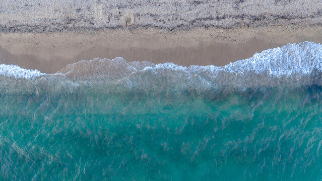 Turquoise Waves Breaking Along the Sandy Shore of Nea Moudania